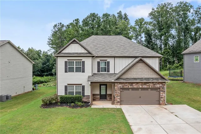 a front view of a house with a yard