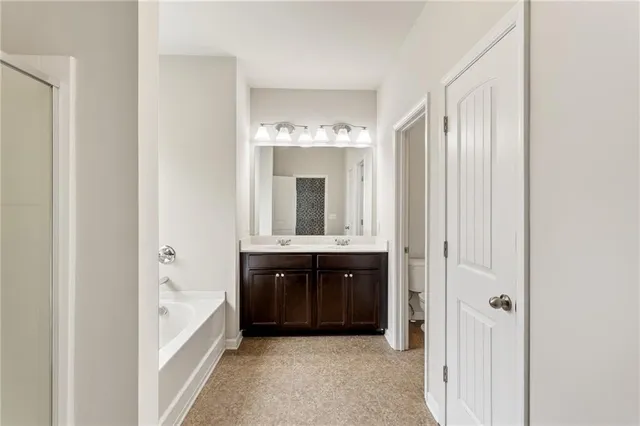 a bathroom with a bathtub sink and mirror