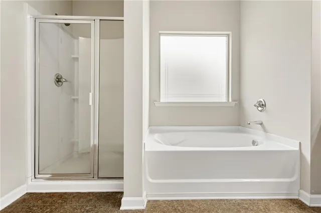 a bathroom with a bathtub and shower