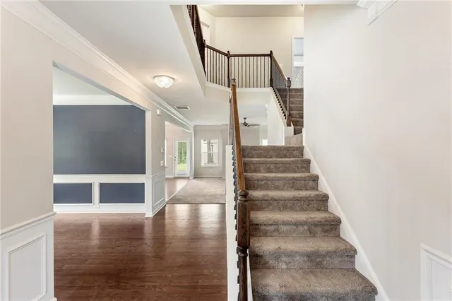 a view of entryway and hall with wooden floor