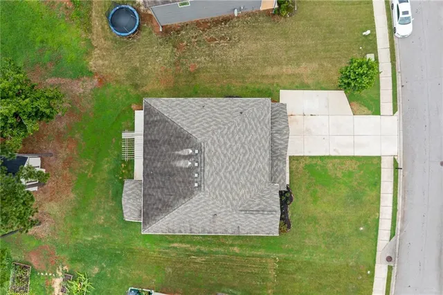 an aerial view of a house with a yard