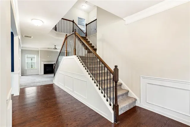 a view of entryway and hall with wooden floor