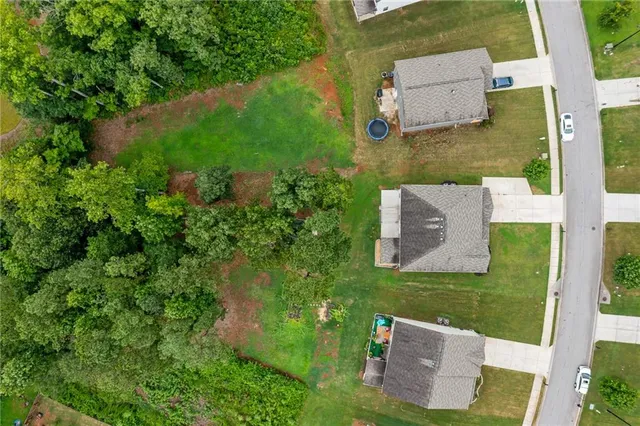 an aerial view of a house with pool garden and lake view