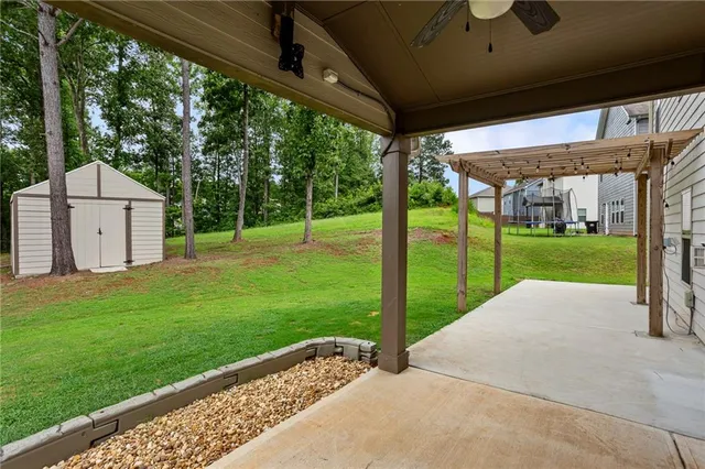 a view of a house with backyard and porch