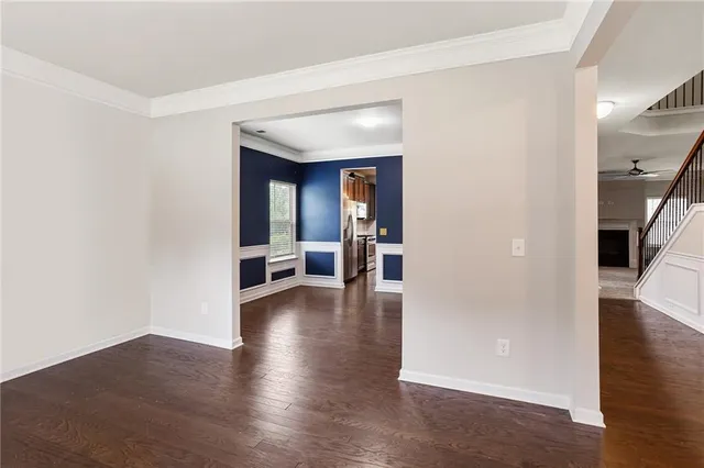 a view of a hallway view with wooden floor and living room