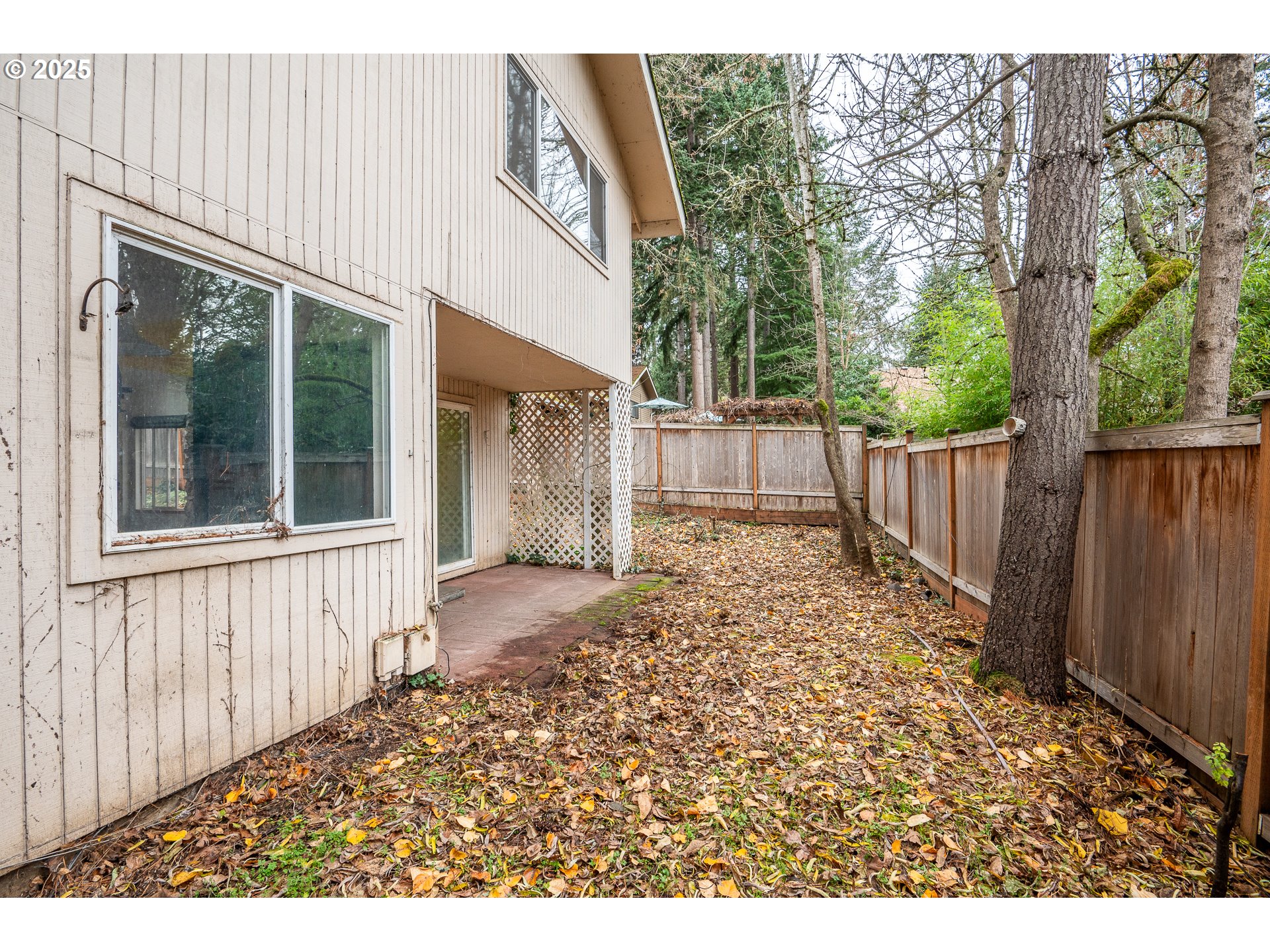 3845 Wilshire Lane Eugene, OR 97405 - Photo 29 of 35 a view of a backyard with wooden fence and large trees