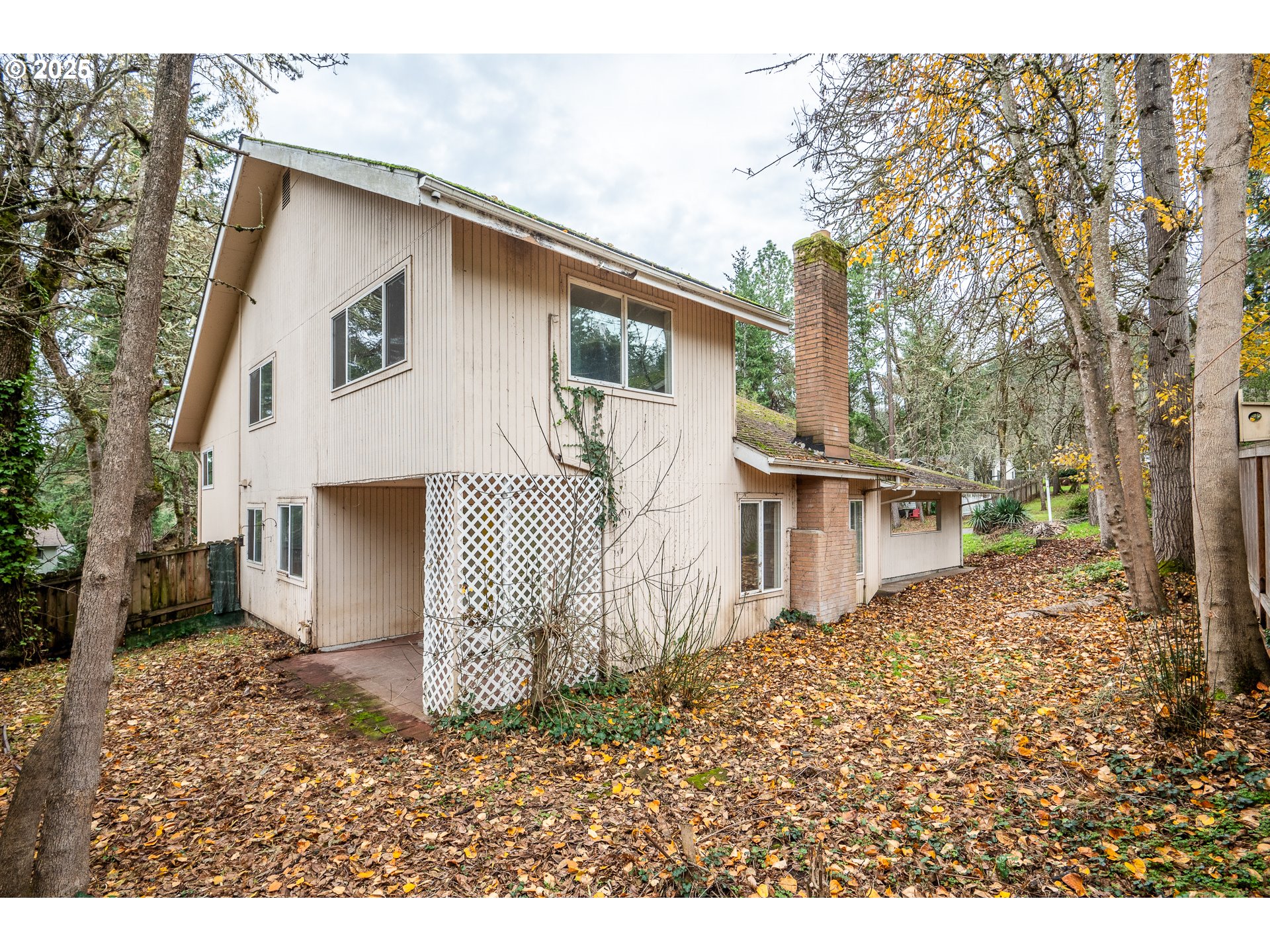 3845 Wilshire Lane Eugene, OR 97405 - Photo 30 of 35 a white house that has a small yard and large trees