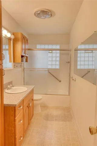 a bathroom with a sink a large mirror and a shower