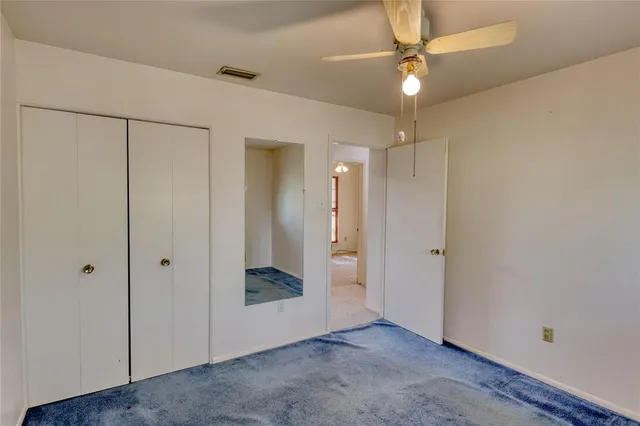 an empty room with a fan