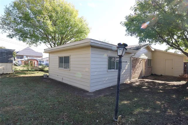 a view of a white house with a yard