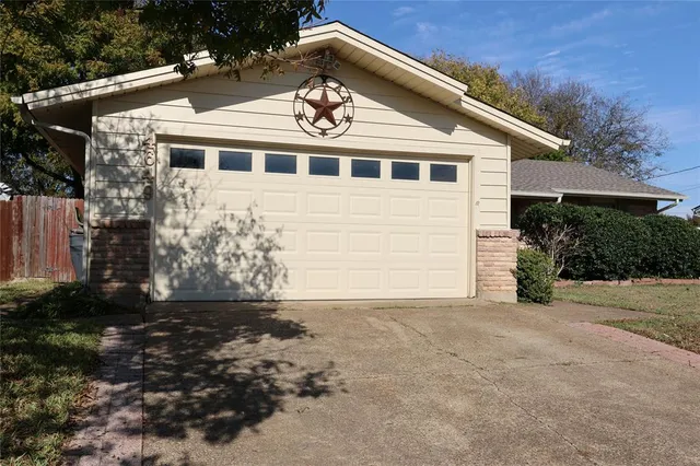 a view of a white house next to a yard