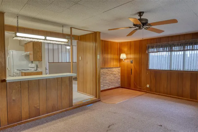 a view of a livingroom with a ceiling fan and window