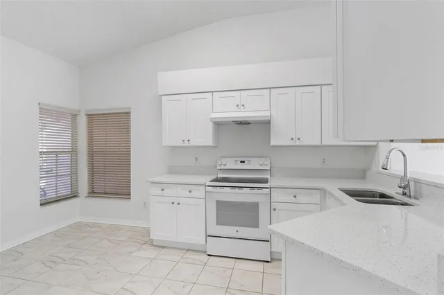 a kitchen with cabinets appliances and a sink