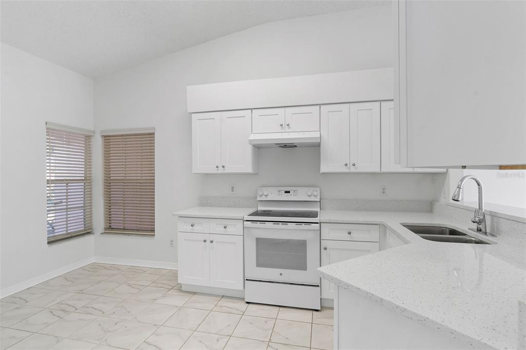 1504 Silktree Court Brandon, FL 33511 - Photo 11 of 26 a kitchen with cabinets appliances and a sink