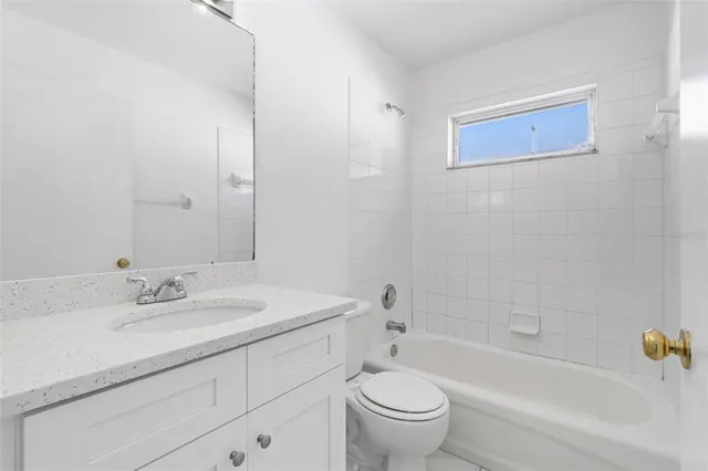 a bathroom with a sink toilet and bathtub