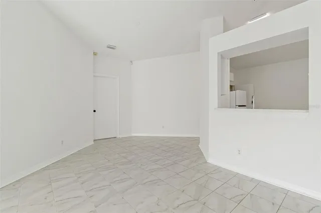 a view of a room with a sink and mirror