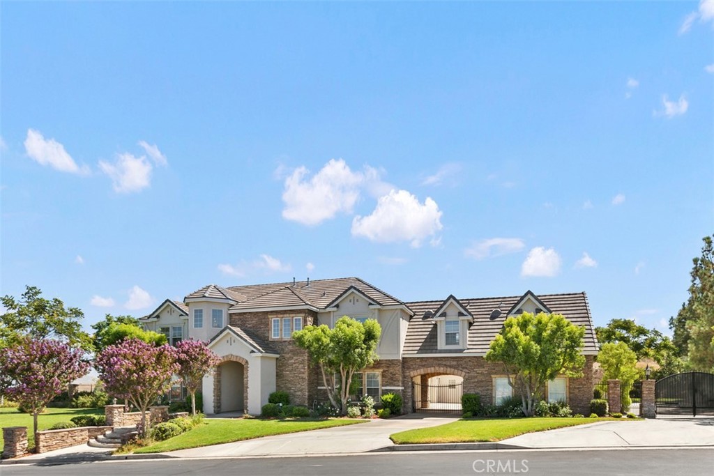 7300 Chateau Ridge Lane Riverside, CA 92506 - Photo 1 of 1 a front view of a house with a yard and garage