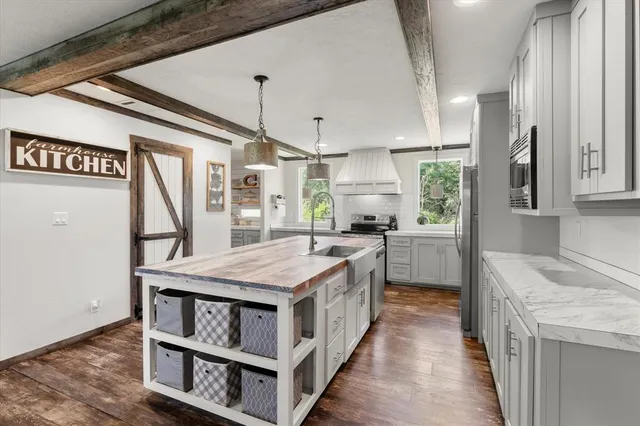 a kitchen with a stove a sink and a refrigerator