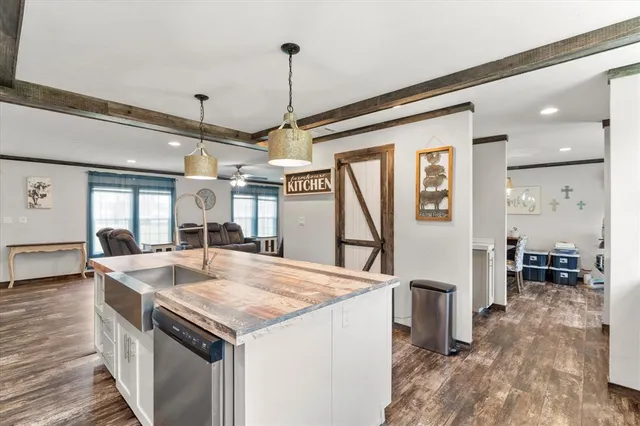 a kitchen with sink stove and refrigerator