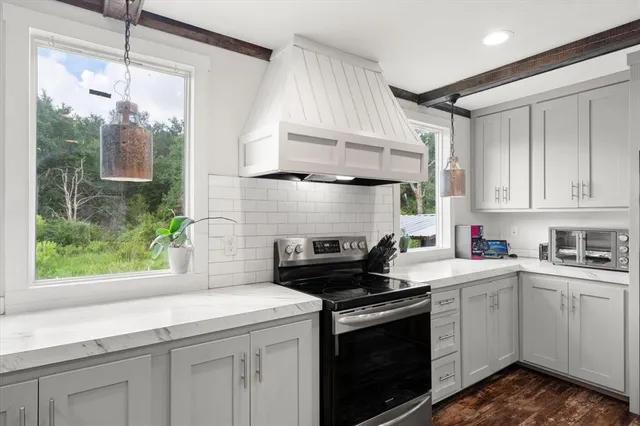 a kitchen with a sink stove and refrigerator