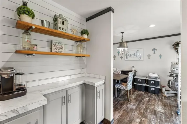 a kitchen with a cabinets and chairs in it