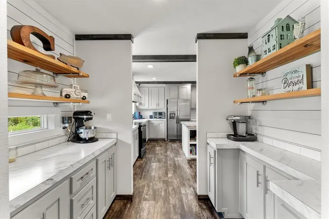 a kitchen with a sink cabinets and appliances