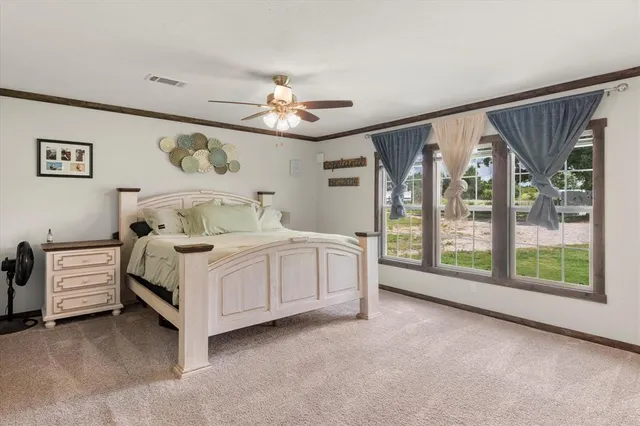 a bedroom with a large bed and a large window