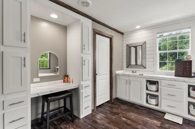 a kitchen with kitchen island a sink cabinets and window
