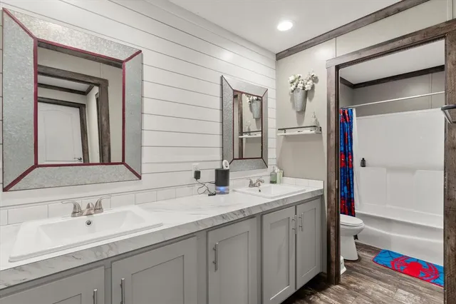 a utility room with wooden floor washer and dryer