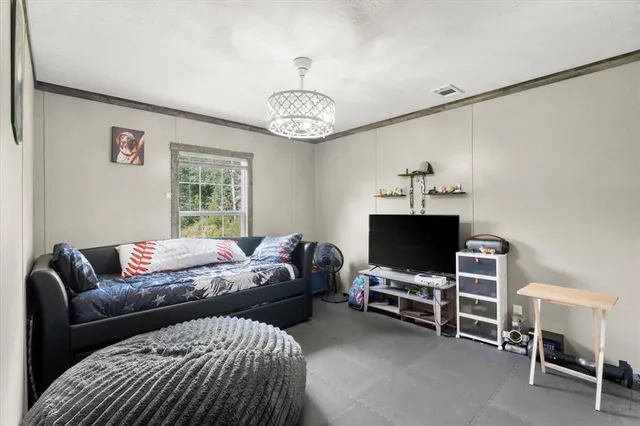 a view of a patio with table and chairs under an umbrella