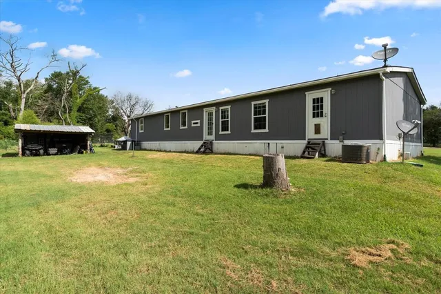 a house view with a sitting space and garden