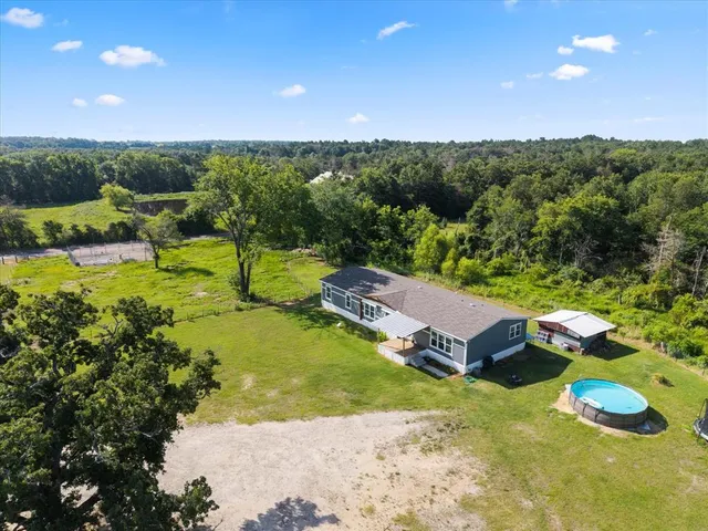 a view of a house with a yard and pool