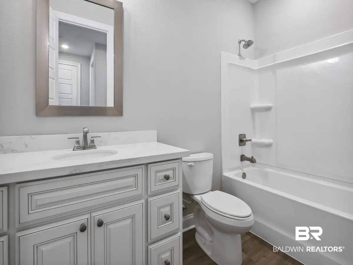 10174 Grady Lane Mobile, AL 36695 - Photo 13 of 14 Full bath featuring vanity, dark wood-style flooring, and shower / tub combination