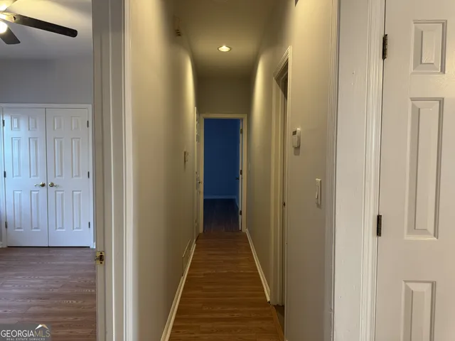 a view of a hallway with wooden floor