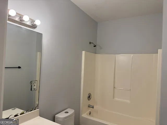 a bathroom with a toilet a sink and bathtub