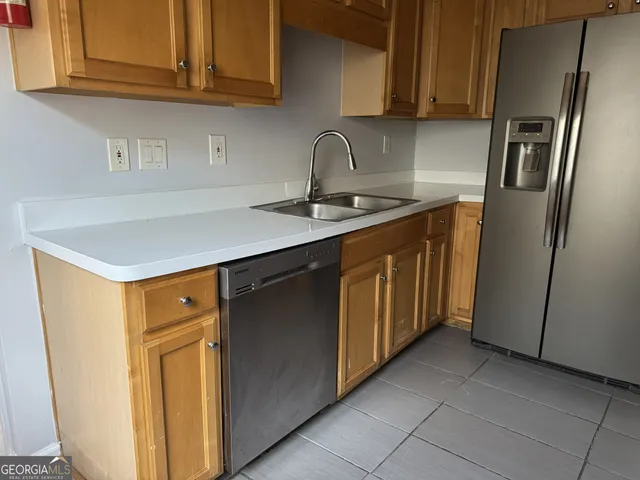 a kitchen with stainless steel appliances a refrigerator and sink