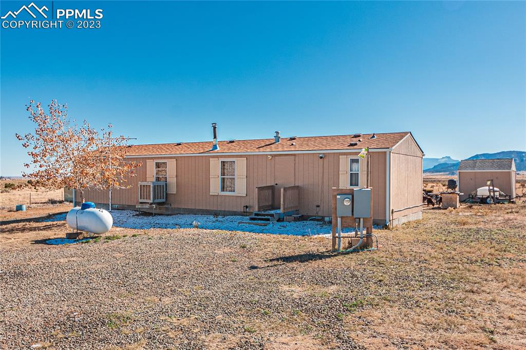 a view of a blue house with a yard