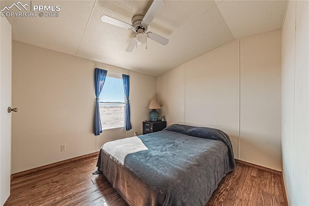 24225 East View Road Trinidad, CO 81082 - Photo 14 of 50 a bedroom with a bed and wooden floor