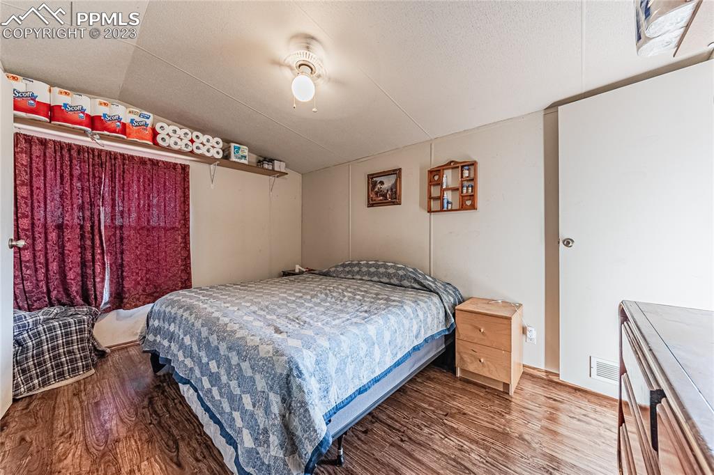 24225 East View Road Trinidad, CO 81082 - Photo 21 of 50 a bedroom with a bed and a chandelier