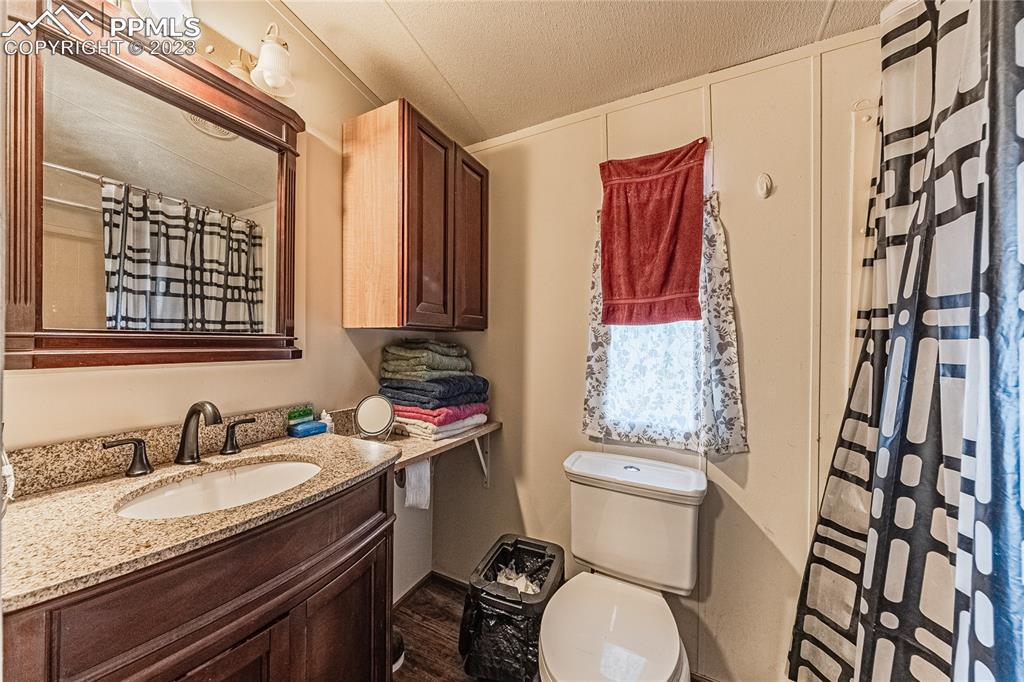 24225 East View Road Trinidad, CO 81082 - Photo 24 of 50 a bathroom with a granite countertop sink toilet and shower