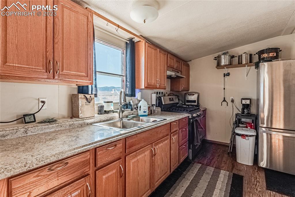 24225 East View Road Trinidad, CO 81082 - Photo 5 of 50 a kitchen with stainless steel appliances granite countertop a sink stove and refrigerator