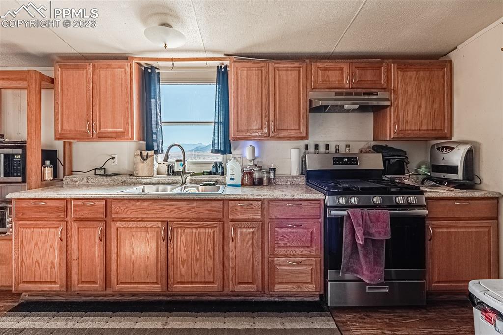 24225 East View Road Trinidad, CO 81082 - Photo 6 of 50 a kitchen with stainless steel appliances granite countertop a sink stove and cabinets