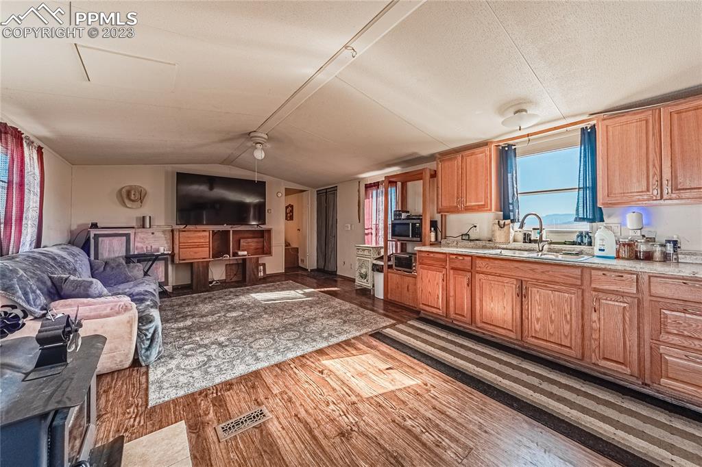 24225 East View Road Trinidad, CO 81082 - Photo 9 of 50 a large open kitchen with stainless steel appliances granite countertop a stove a sink dishwasher and cabinets with wooden floor