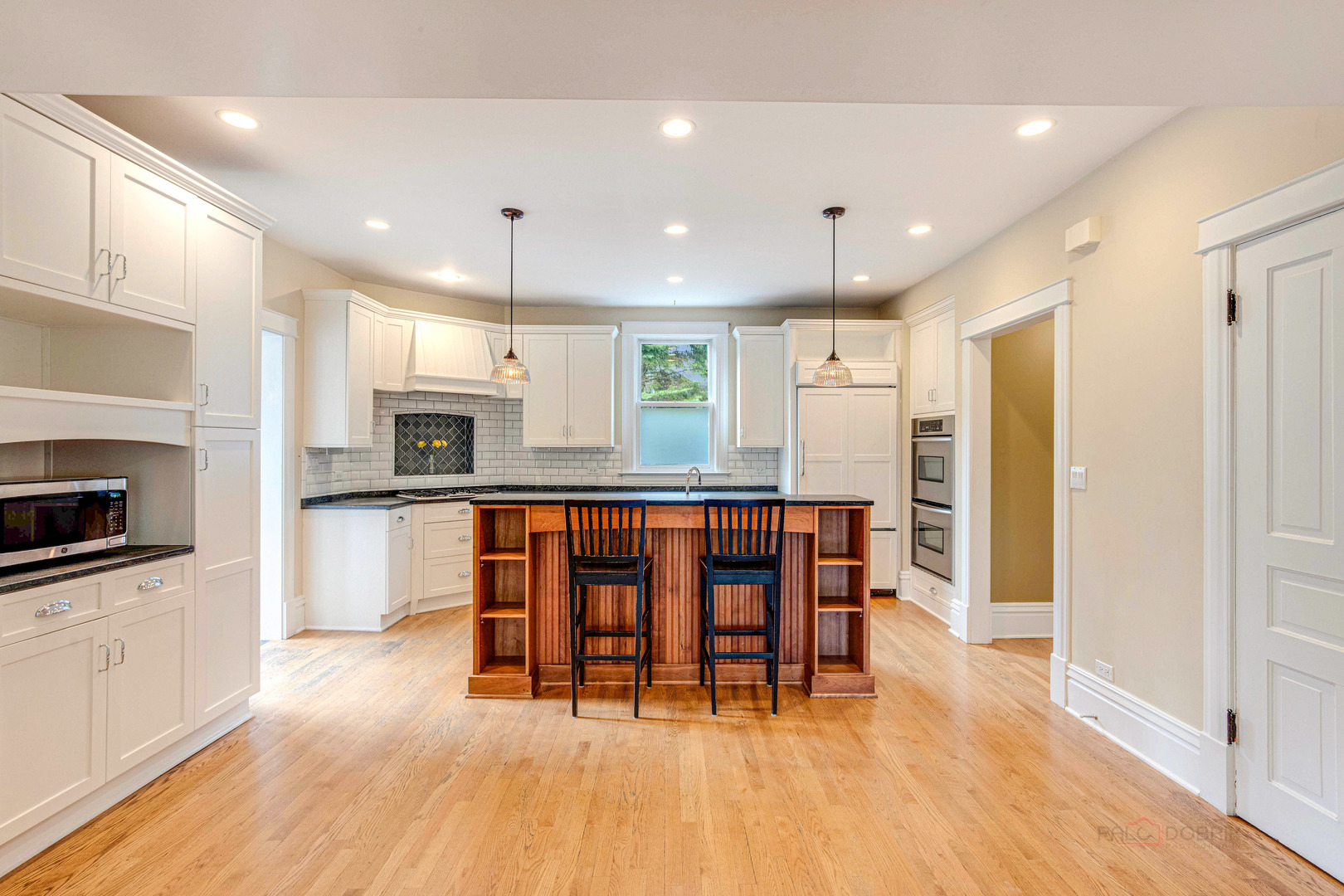 71 Washington Road Lake Forest, IL 60045 - Photo 18 of 39 a kitchen with stainless steel appliances kitchen island granite countertop a stove a sink a refrigerator and a microwave