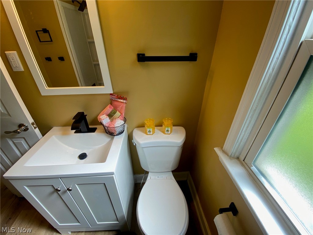 2508 Greenvale Road Cleveland, OH 44121 - Photo 13 of 16 Bathroom with vanity, toilet, and hardwood / wood-style flooring