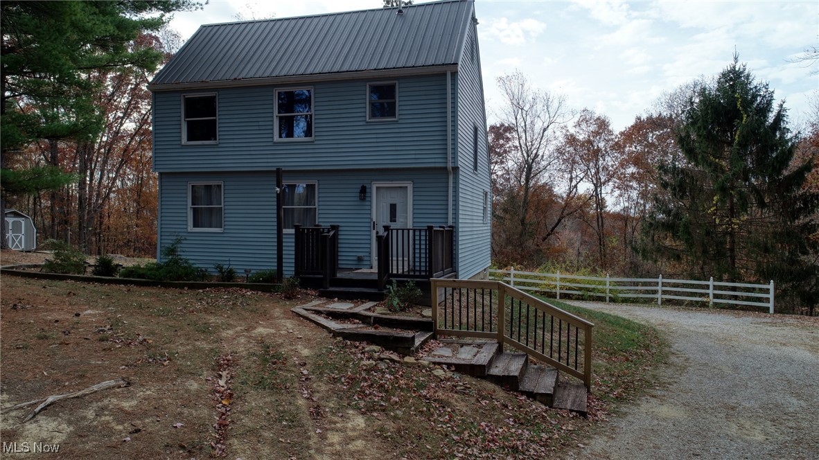 66565 Lake Ridge Road Lore City, OH 43755 - Photo 2 of 26 View of front of house featuring a storage unit