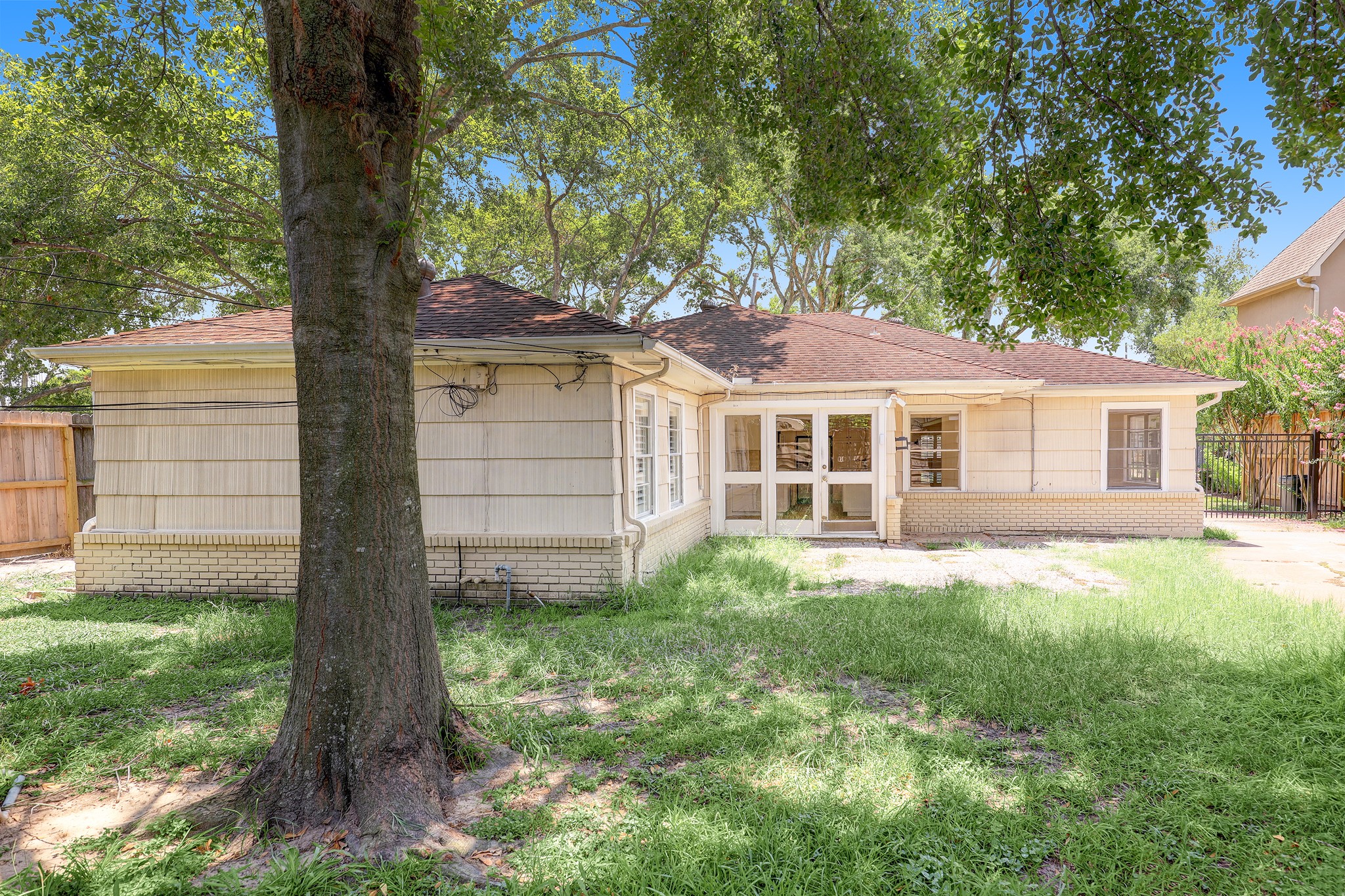 5642 Wickersham Lane Houston, TX 77056 - Photo 21 of 22 Spacious backyard is fully fenced and shaded by mature trees. Perfect for weekend bbq's!
