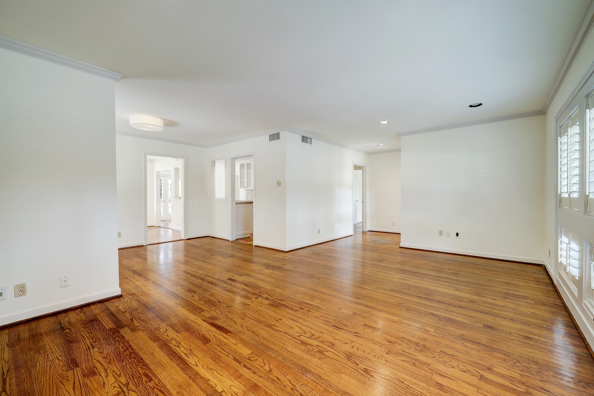 5642 Wickersham Lane Houston, TX 77056 - Photo 5 of 22 View of living room looking into the dining room with kitchen entrance to the right and den to the left.