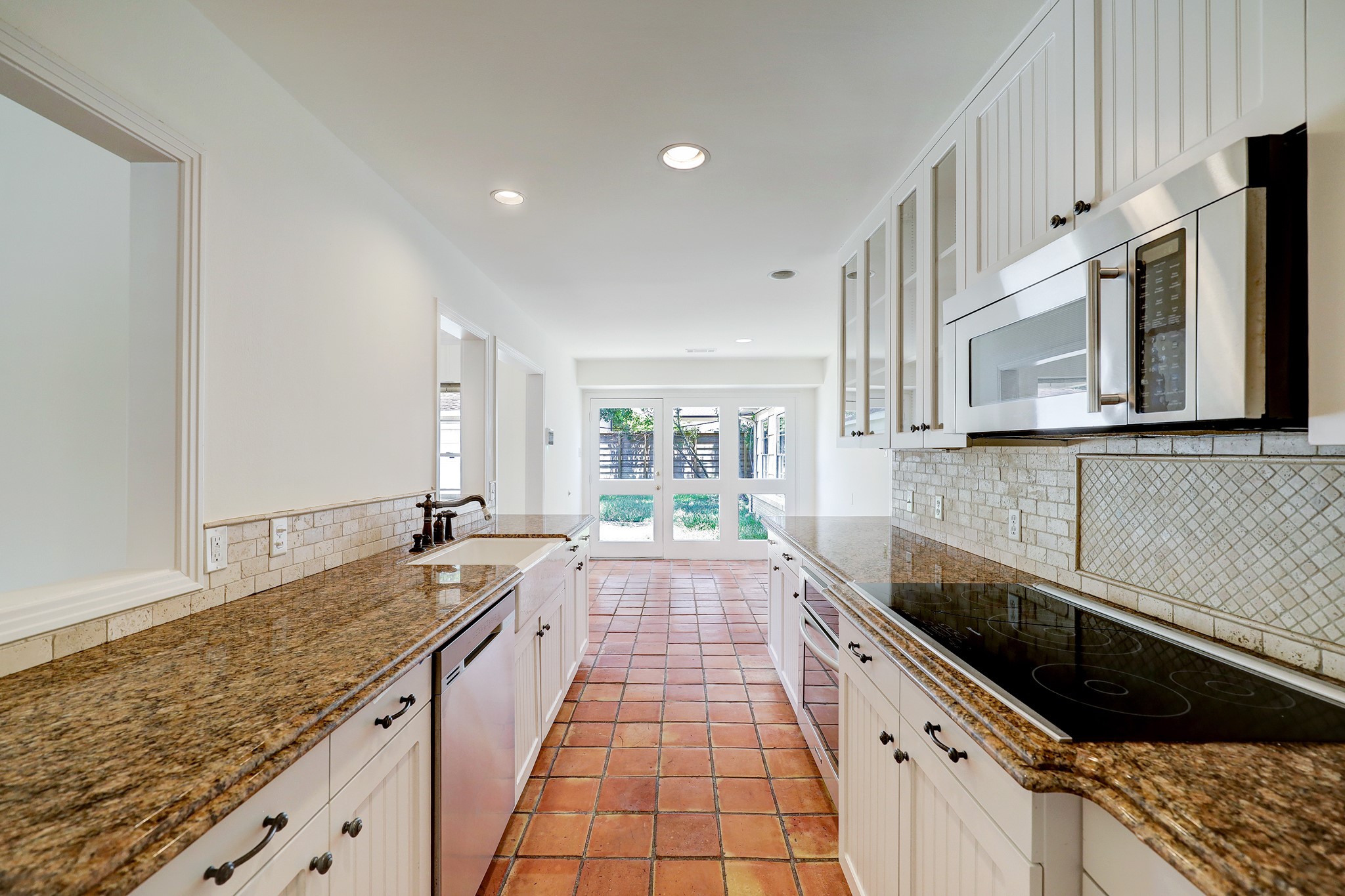 5642 Wickersham Lane Houston, TX 77056 - Photo 9 of 22 The galley kitchen with granite countertops leads into the breakfast area.