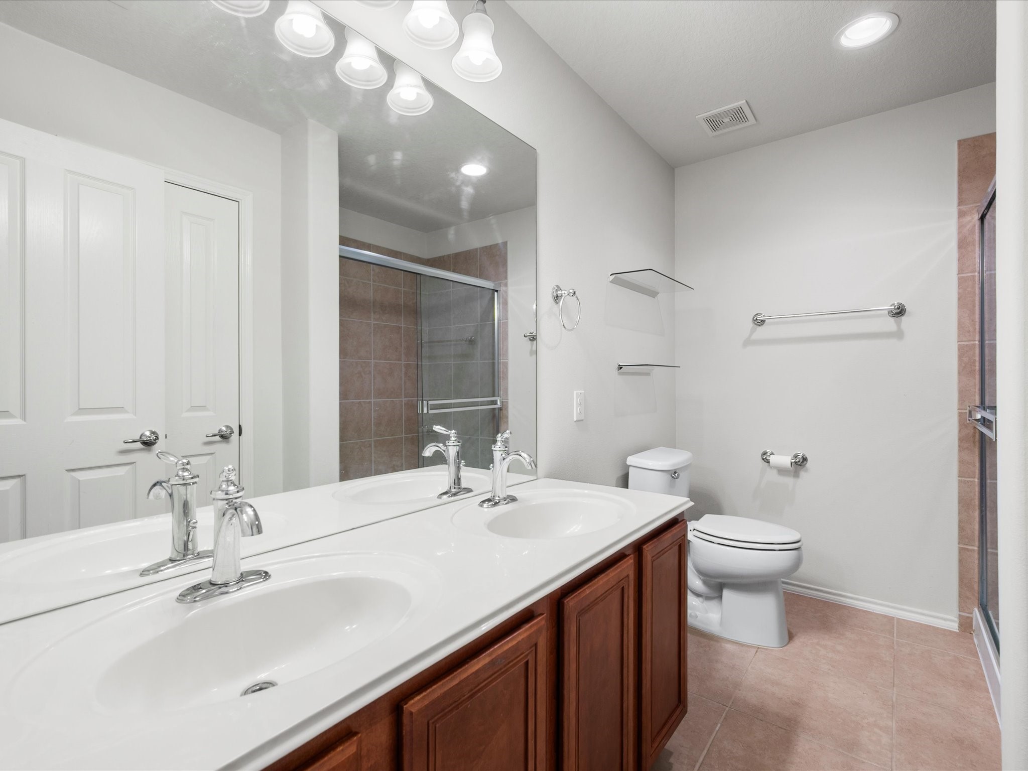 13600 Breton Ridge Street, Unit 31C Houston, TX 77070 - Photo 20 of 31 The spacious en-suite bath is thoughtfully designed with ample counter space, abundant storage, and a comfortable layout that makes daily routines feel effortless.
